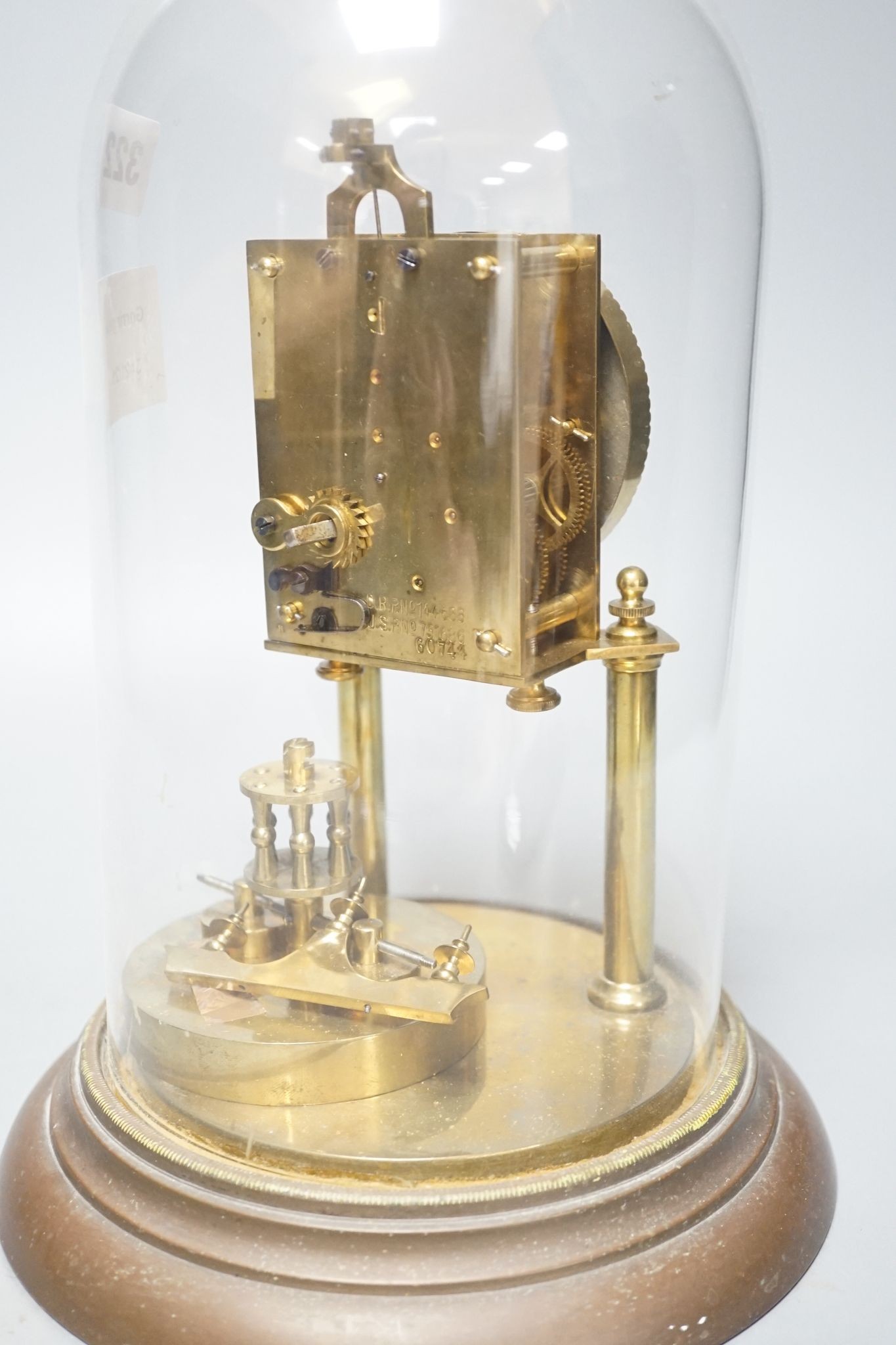 An early 20th century month going mantel timepiece, with a silk suspension, under a glass dome 29cm